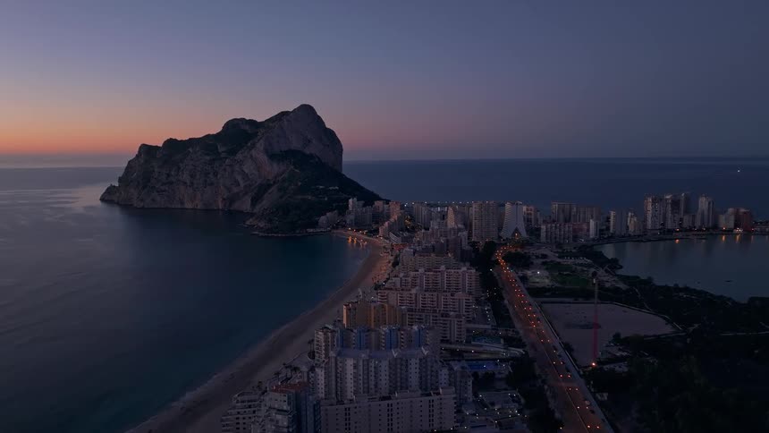 Buildings on the coast of the iberian peninsula with the rock of gibraltar overlooking the sea