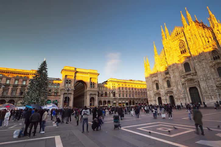 A time lapse of people in a square in front of a building
