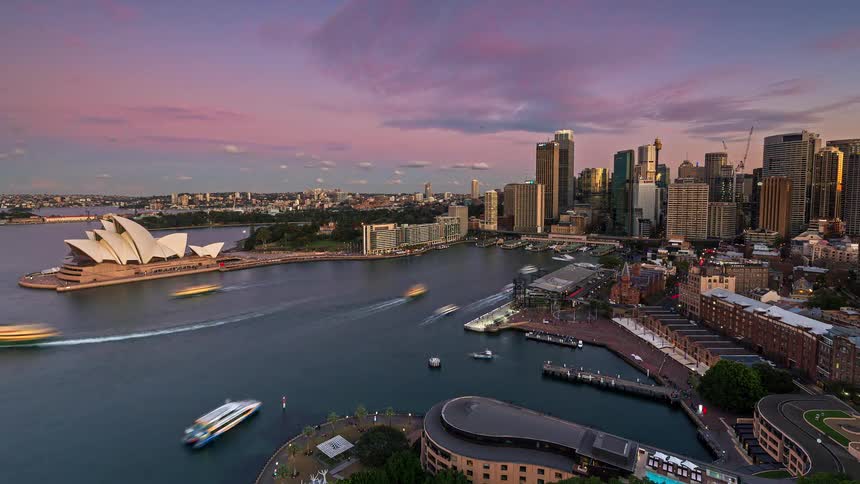 A time lapse of a city with the sun setting above it