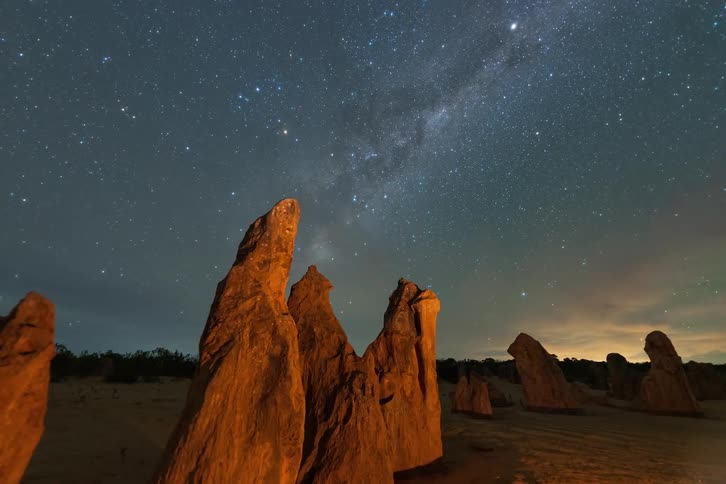 A time lapse of stars above a desert landscape