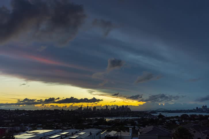 Time lapse of a cloudy sky above a metropolitan city skyline