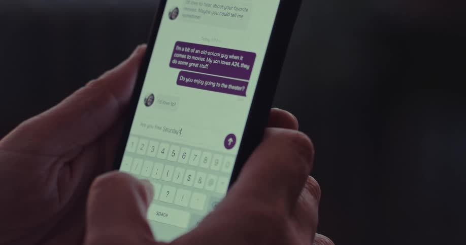 A person types a message into their smart phones and sends it