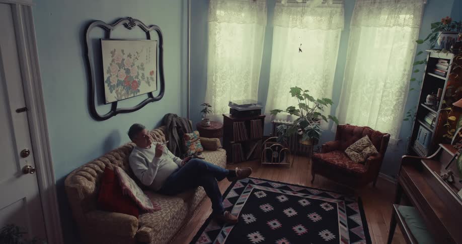 A man sitting on a couch in a house