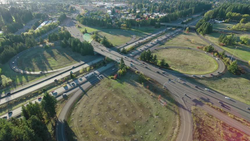 Pull back reveal over flowing traffic on a clover leaf highway interchange