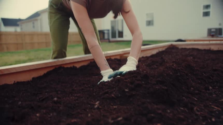 A woman working on a container garden
