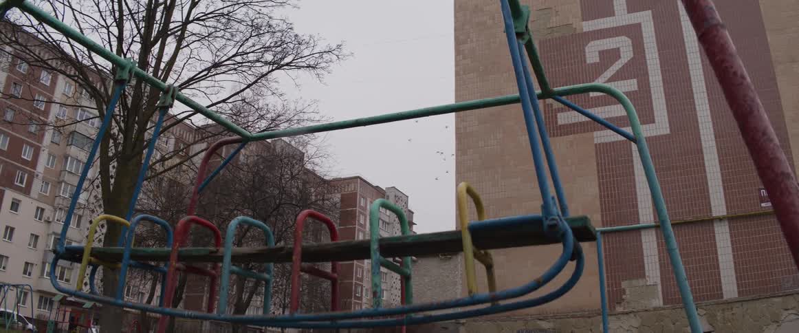 Colorful playground structure in front of building marked with number two
