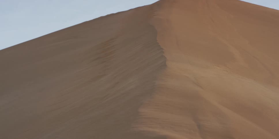 A view of a sand dune on a sunny day