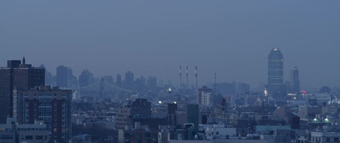 View of large smoggy city after sunset