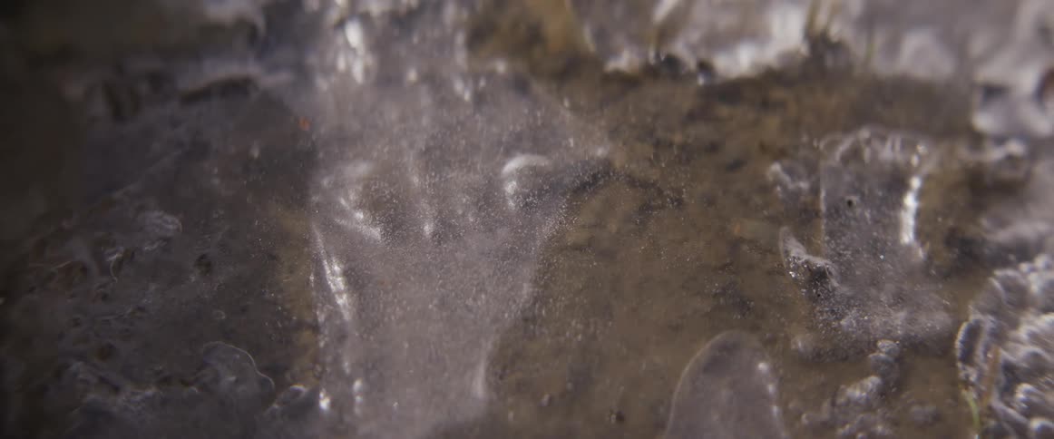 A close up of water flowing on ice
