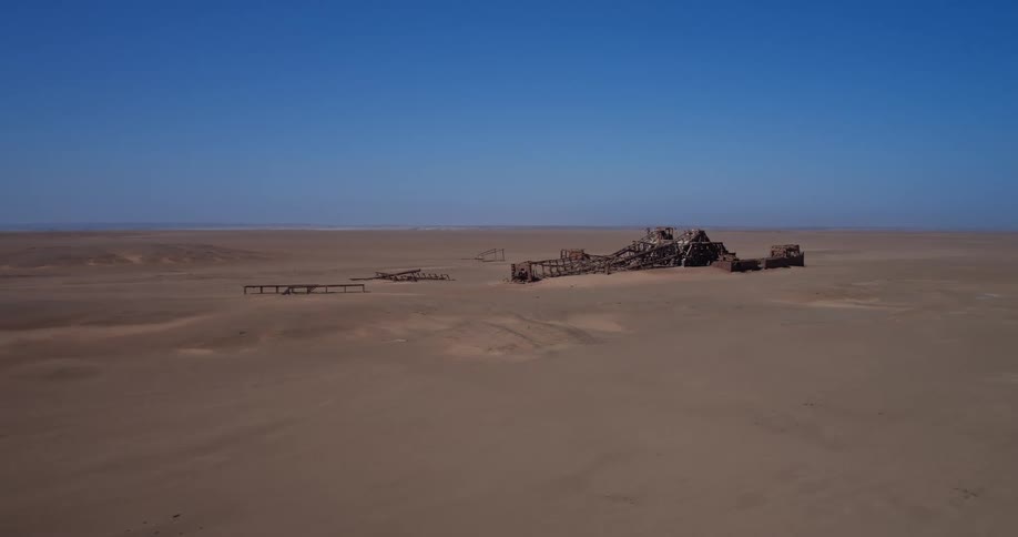 Abandoned industrial structure in vast desert plain