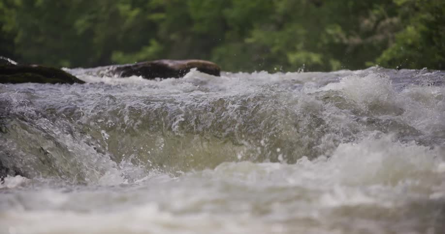 Slow motion of a river with a very small waterfall