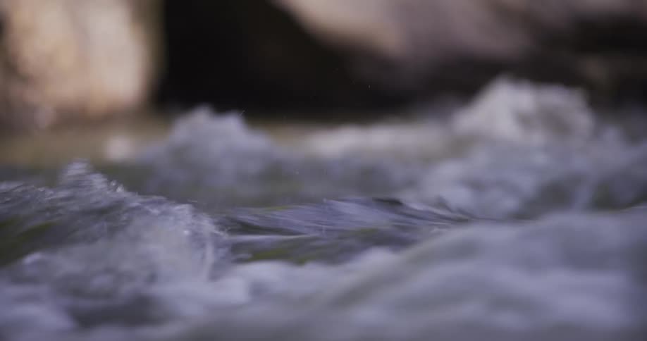 Water splashes as the river flows off the coast