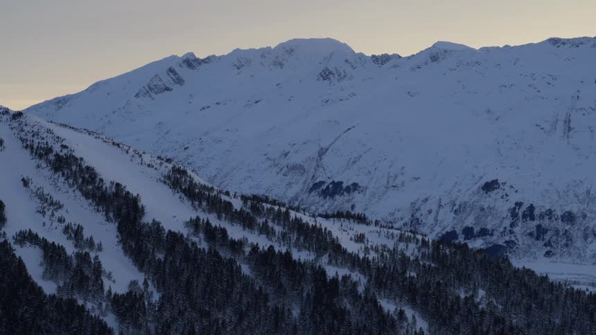 An aerial view of a mountain covered in snow