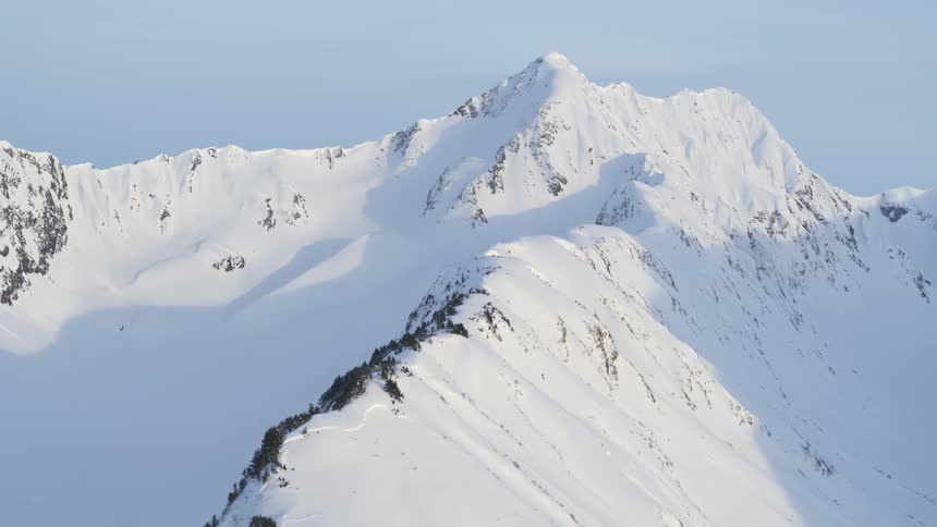 Snowcovered mountain peak under clear sky