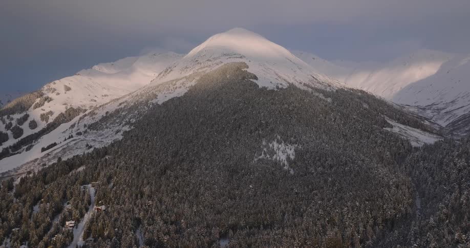 An aerial view of a mountain covered in snow