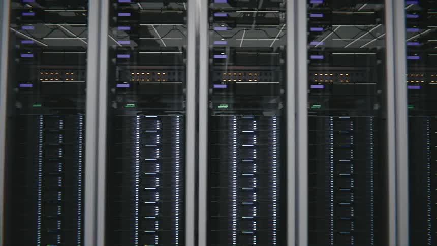 Numerous data servers are installed in rack mounts in a long row