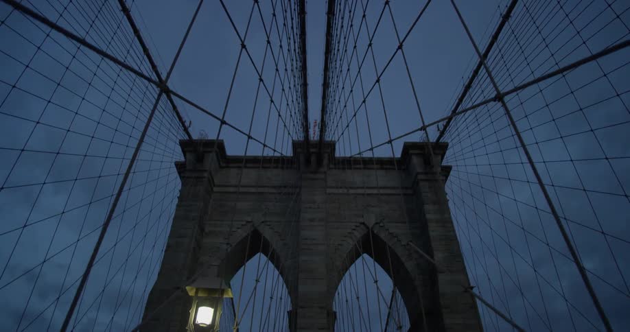 View looking up at the beams and supports of a bridge