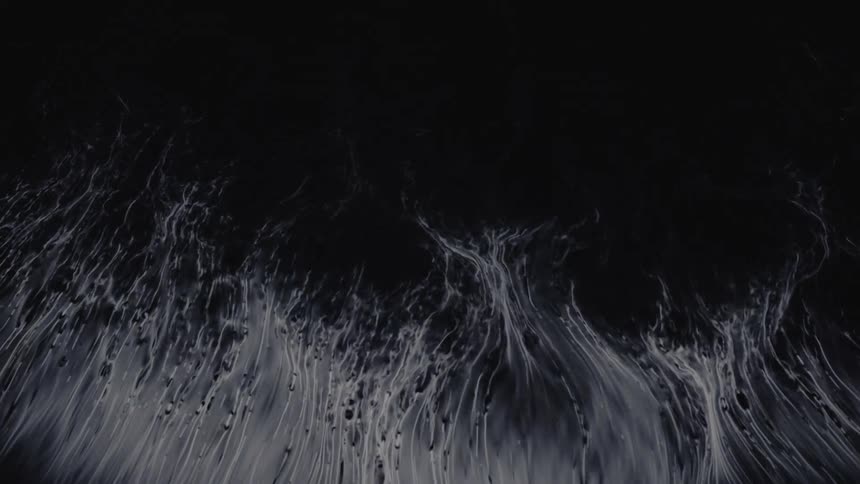 Ethereal white tendrils of ink slowly spread out and dissipate in a dark liquid