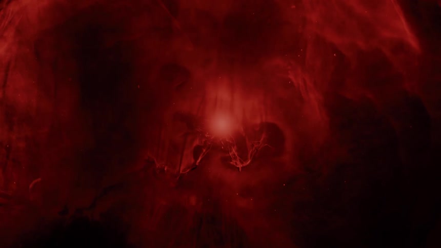 A mysterious red nebula pulses with light from its core in the vast darkness of space