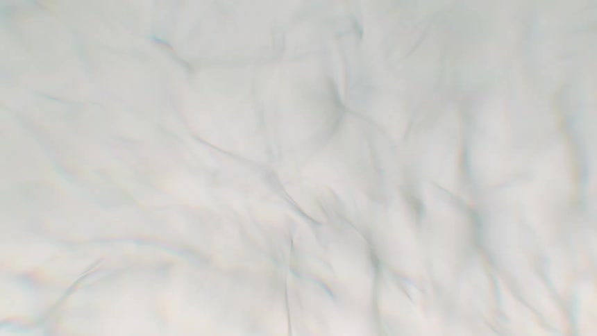 Ethereal background of gently shifting white silk-like texture with subtle rainbow light refractions