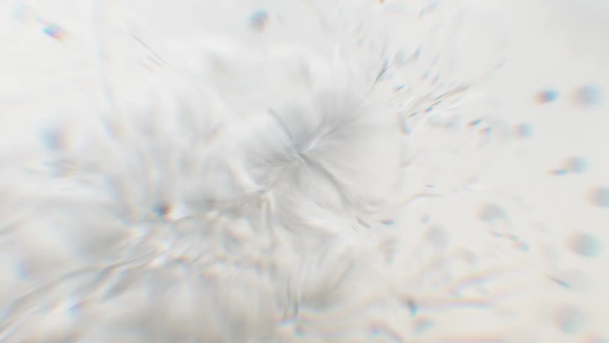 Dreamy abstract background of a white, liquid-like texture gently swirling and pulling inward