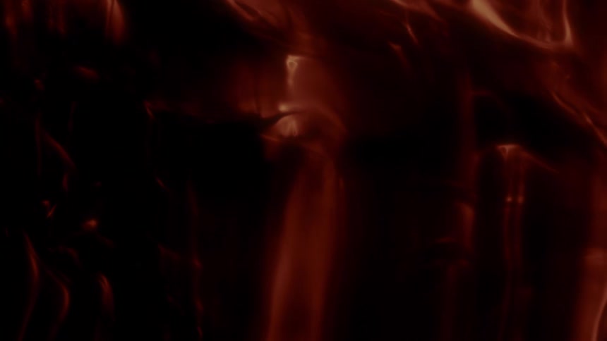 Slow-moving abstract shapes in deep red and black create a dark and mysterious background