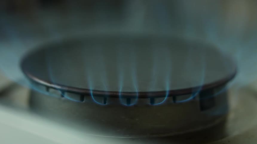 A stove top flame turns on and off