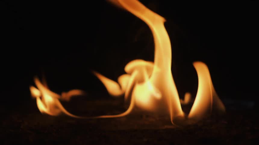 A fire burns on the ground