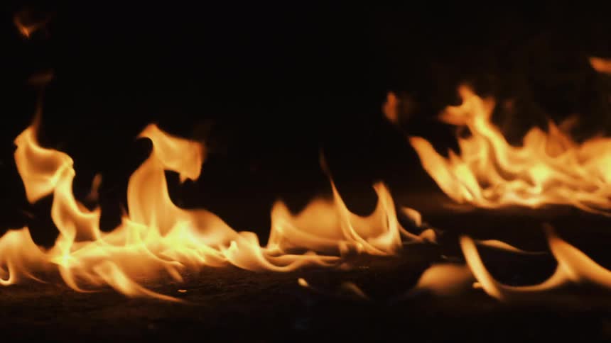 The fire burns in the dark area