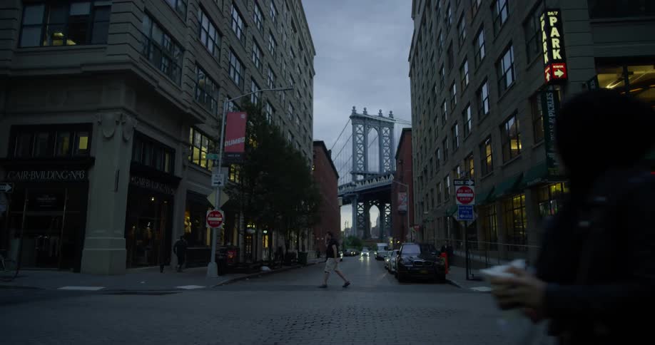 People walk along the sidewalk of the city