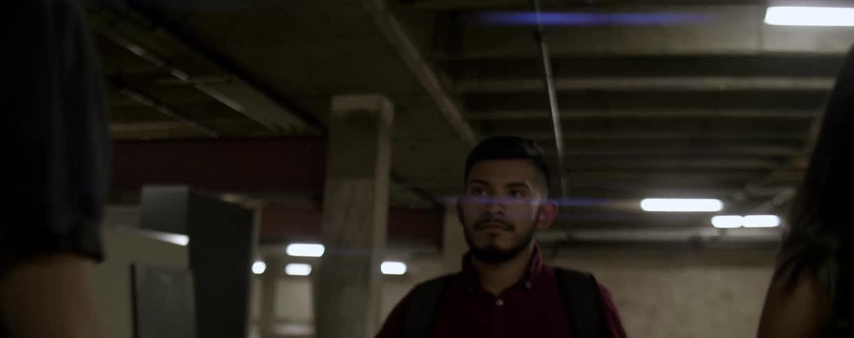 People walking in a underground parking garage,