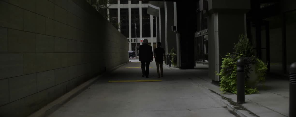 Man and woman walking down an alleyway in a city