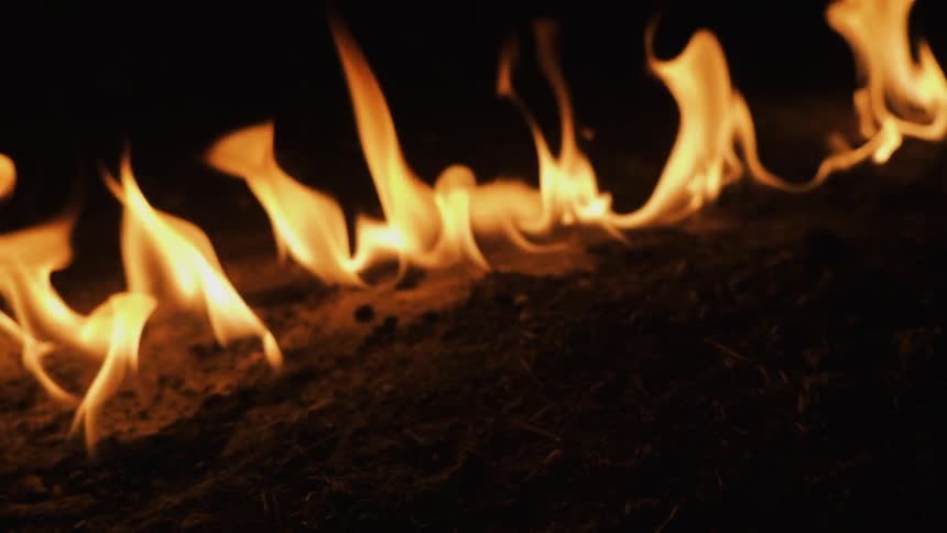 The ground burns in a line in the dark
