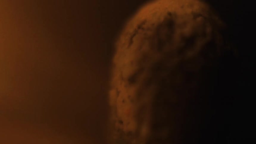 Flames near a stone looking object
