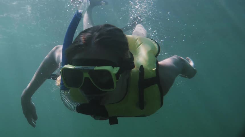 Woman with snorkel gear in the water