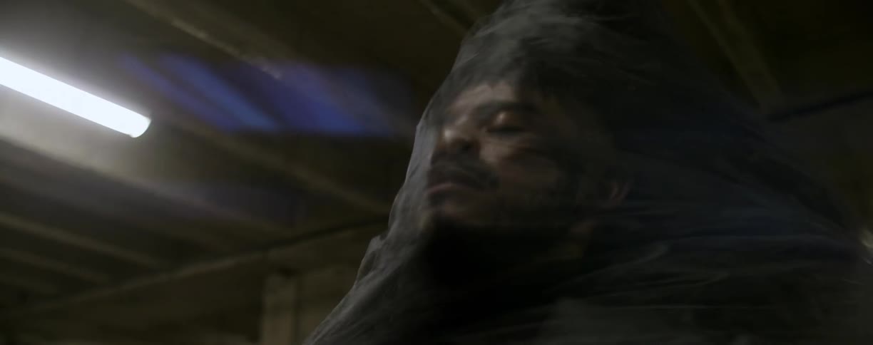 A supernatural figure wraps around a man's face