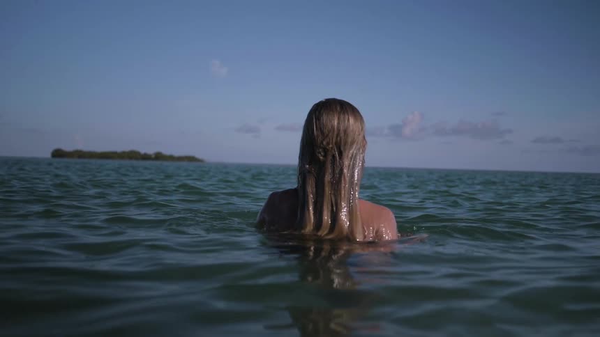 Woman emerges from water