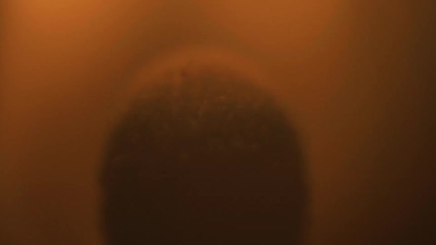 A close up of a match blazing in the dark