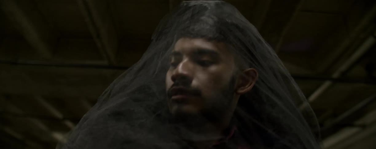A supernatural figure wraps around a man's face