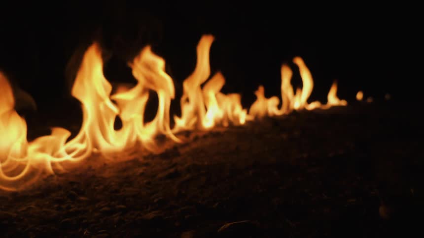 A fire burns in a straight line on the ground