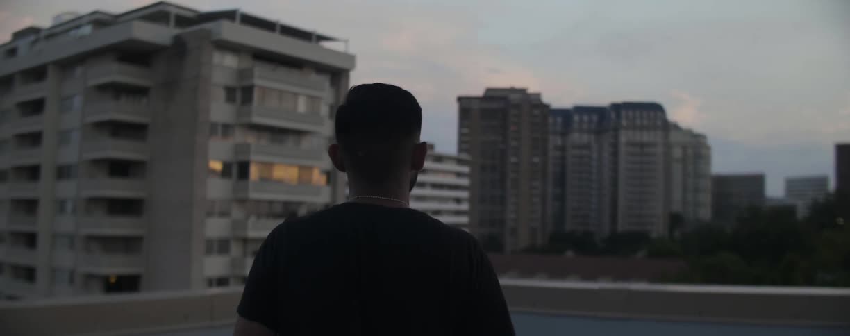 Man walking on top of a parking ramp downtown