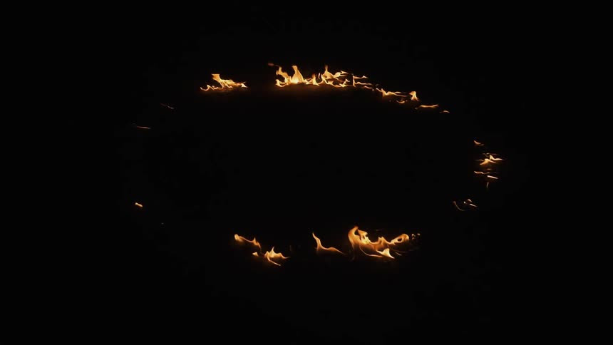 A fire burns in a ring on the ground
