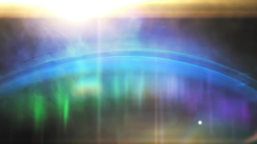 A vibrant aurora borealis dances across a planet's atmosphere as a bright star shines from above in deep space