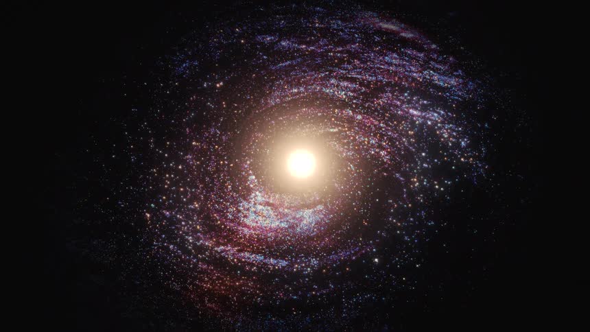 A majestic spiral galaxy with a glowing core slowly rotates in the vast darkness of deep space
