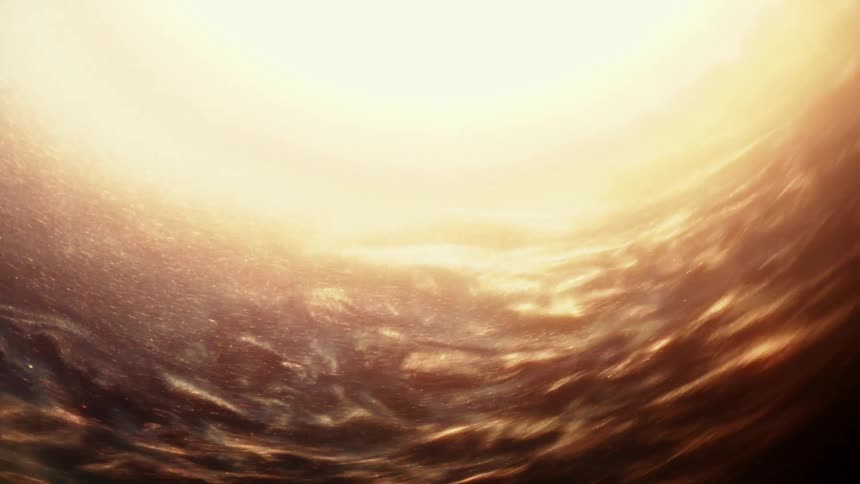 A mesmerizing vortex of glowing gold particles and light creates a warm abstract background