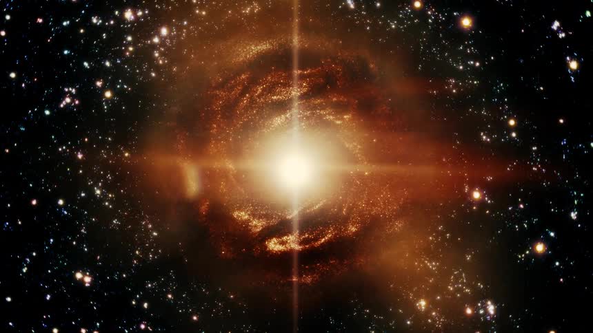 An animated journey through space, pulling back from the bright center of a fiery orange galaxy