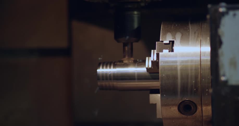A workshop has a machine drilling into metal