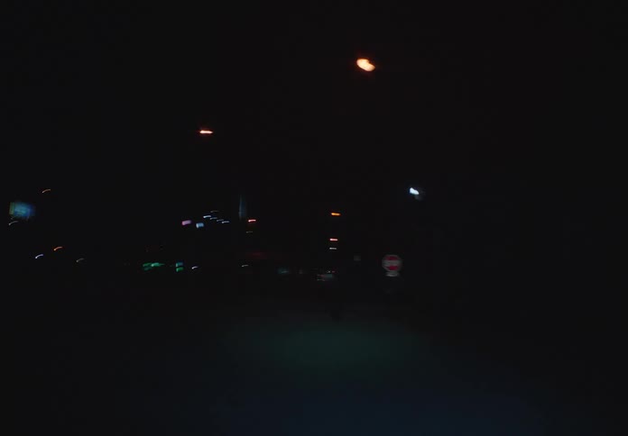 A disorienting shaky camera follows a man as he runs on a dark street at night in high speed