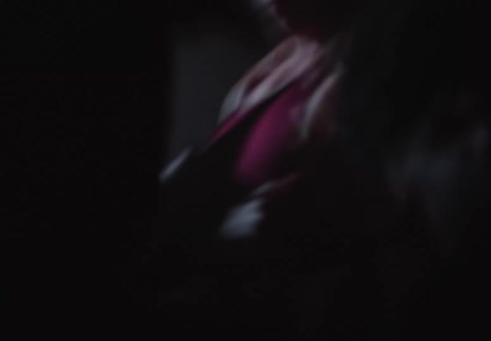 An abstract and shaky close-up captures the intense crowding of a young male athlete in a dark room
