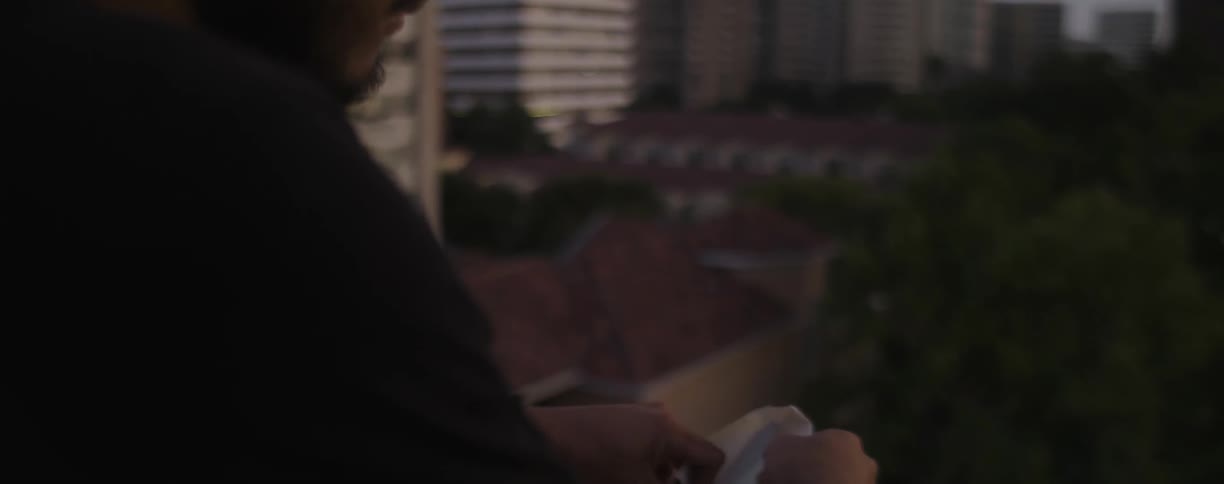 A man sits down, and opens a letter at dawn